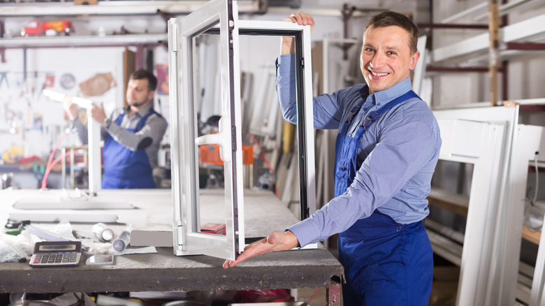 man holding window in factory