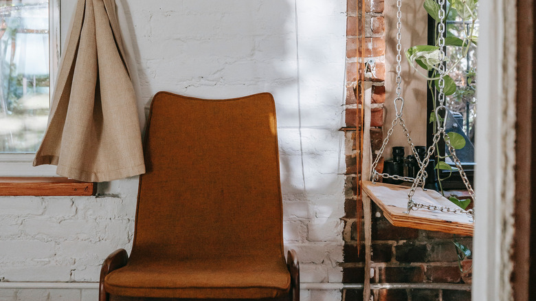 orange chair on white wall