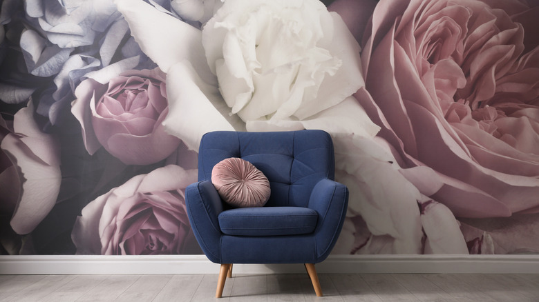 blue chair with floral wallpaper 