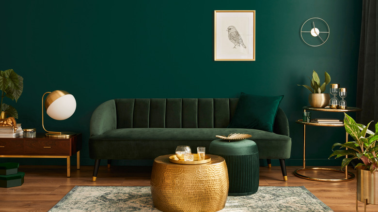 Green couch and gold coffee table