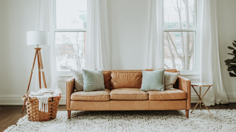 neutral pillows on brown sofa