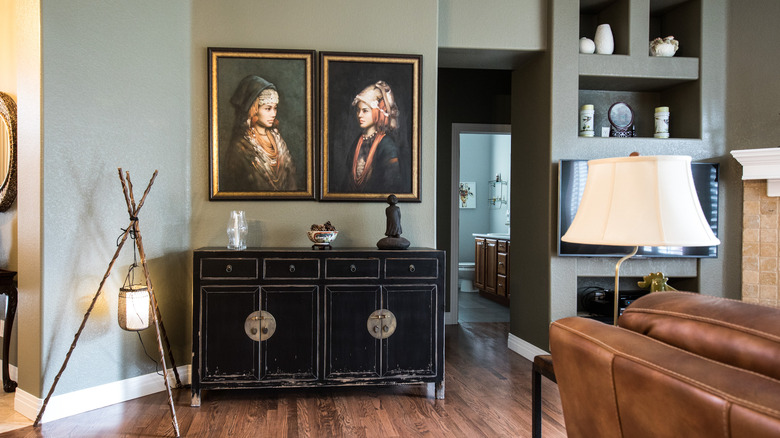 unique portraits above sideboard 