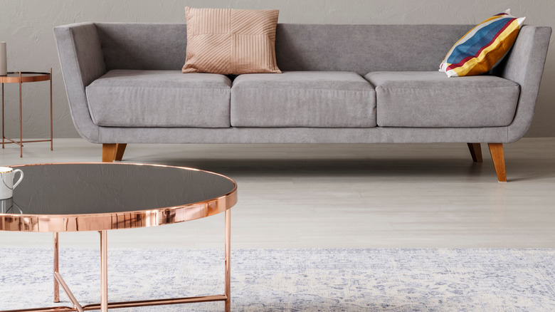 metallic coffee table with couch