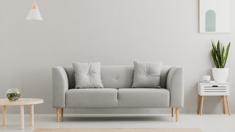 gray couch with pillows