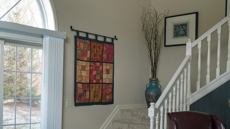 wall tapestry by stairs