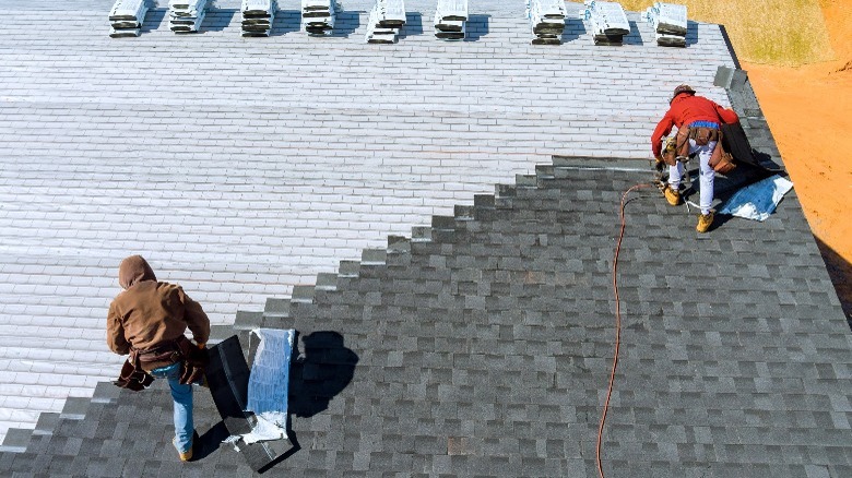 people installing asphalt shingles 