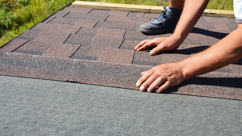 person applying roof underlayment 