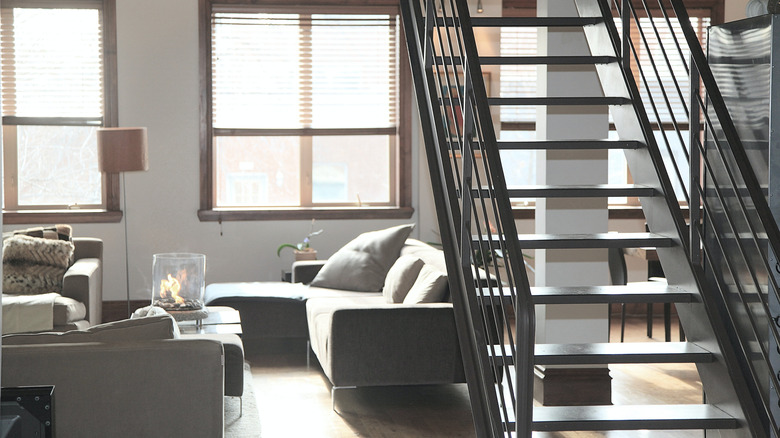 living room with modern metal staircase