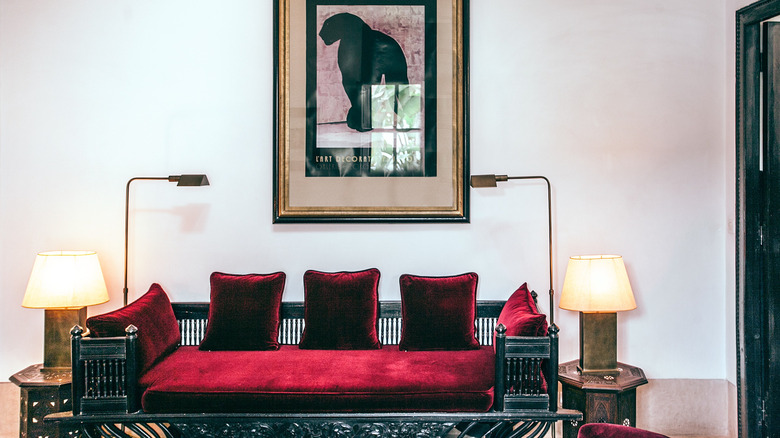 red velvet couch and side tables