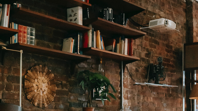 Pipe bookshelves accent a brick wall 