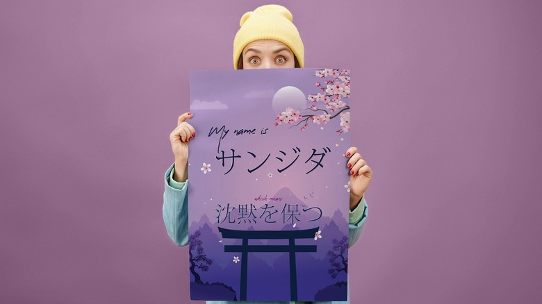 woman holding purple poster 