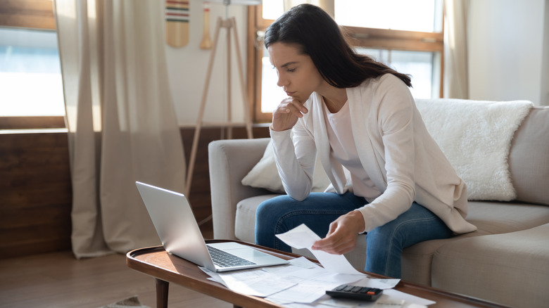 young woman looking at laptop