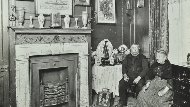 Victorian couple sitting by fireplace