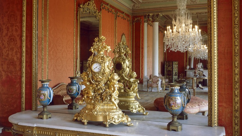 chandelier and gold clock on mantel