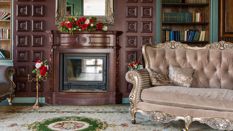 ornate sofa next to fireplace