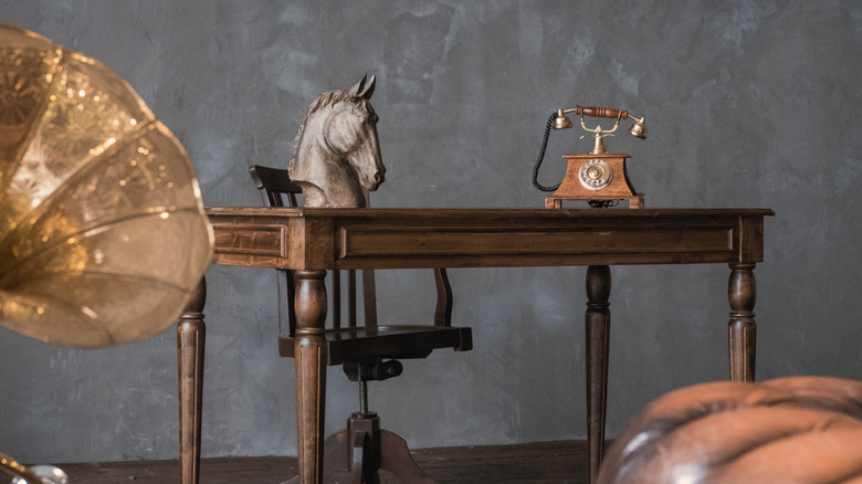 antique phone on wooden desk