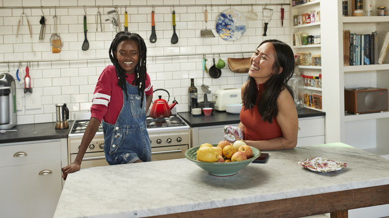 friends laughing in kitchen