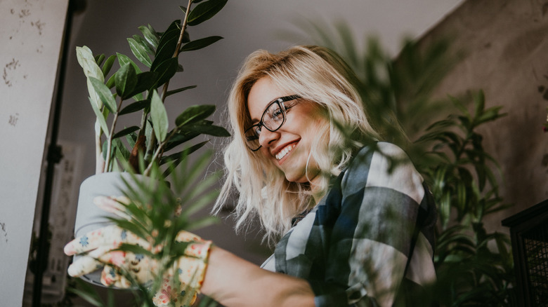 Woman smiling while holding planter