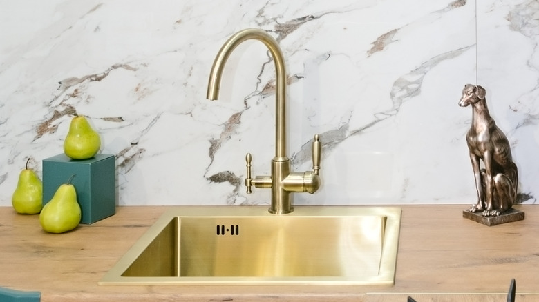 Gold kitchen sink and matching faucet