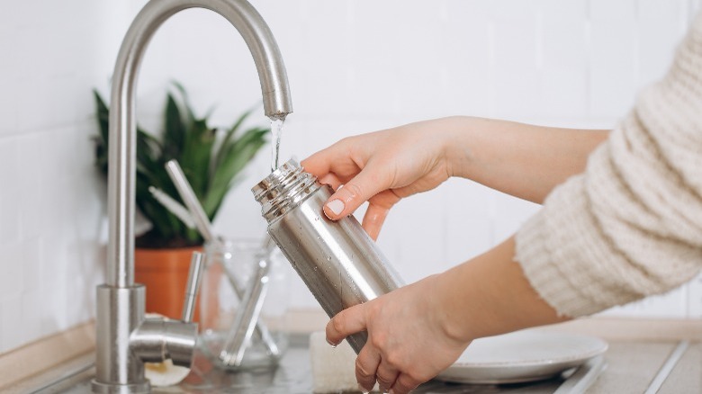 Lady cleaning a tumbler