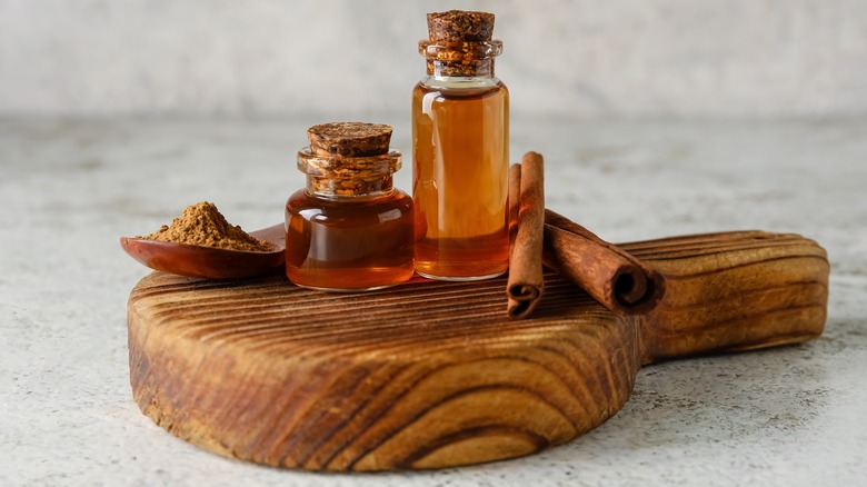 Cinnamon oil and sticks on platter