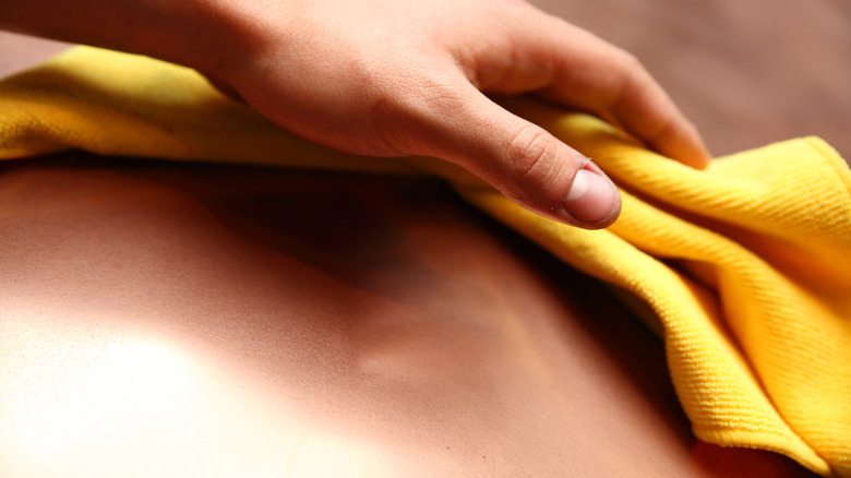 Person cleaning copper with cloth