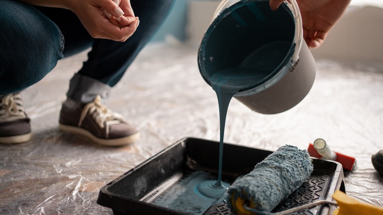 man pouring paint