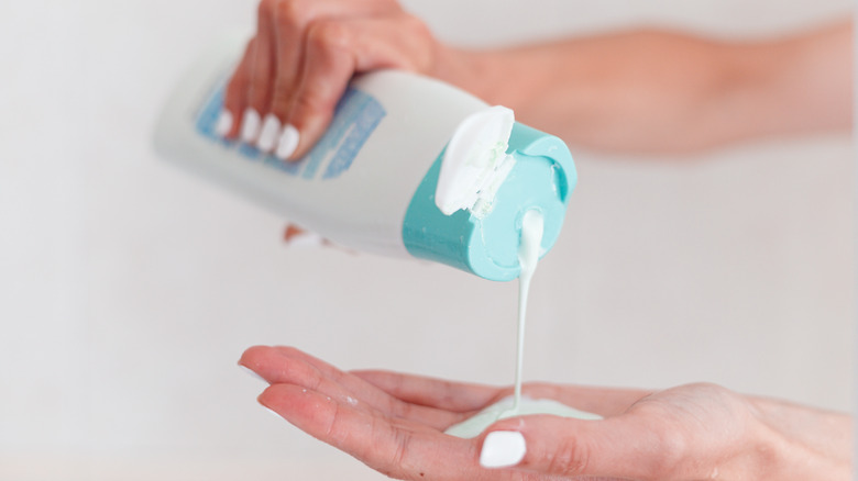 person pouring shampoo