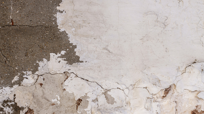 A closeup of an old limewashed wall with signs of wear