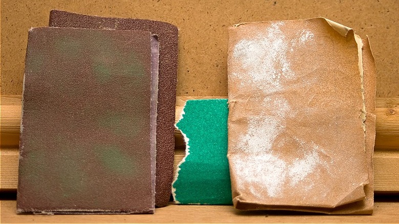 Pieces of sandpaper against wood