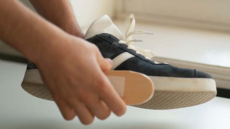 Someone cleaning sneakers