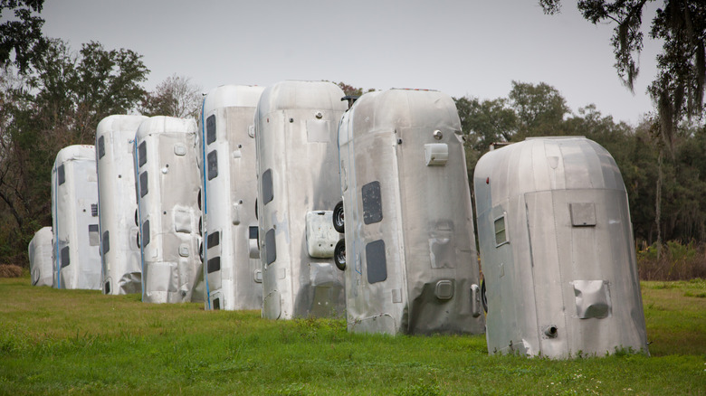 An Airstream cemetery in woods