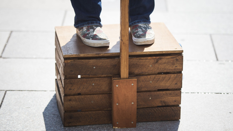 Feet standing on a soapbox