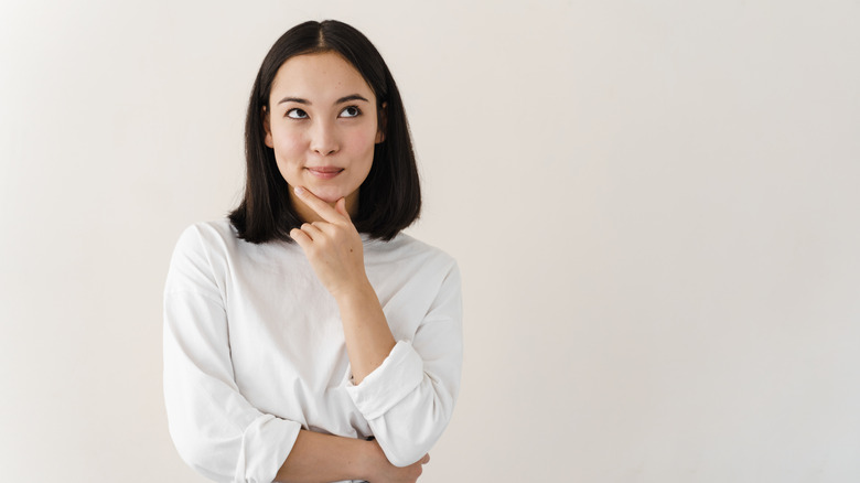 woman deliberating over choice