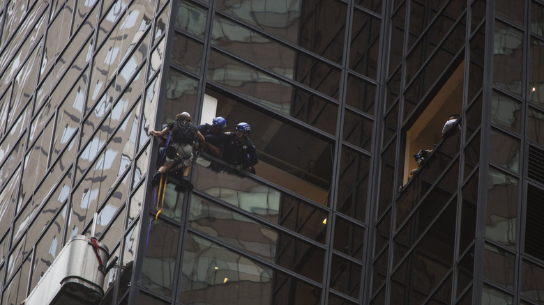 A man climbing Trump Tower