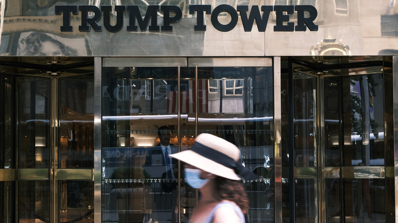 A woman in front of Trump Tower