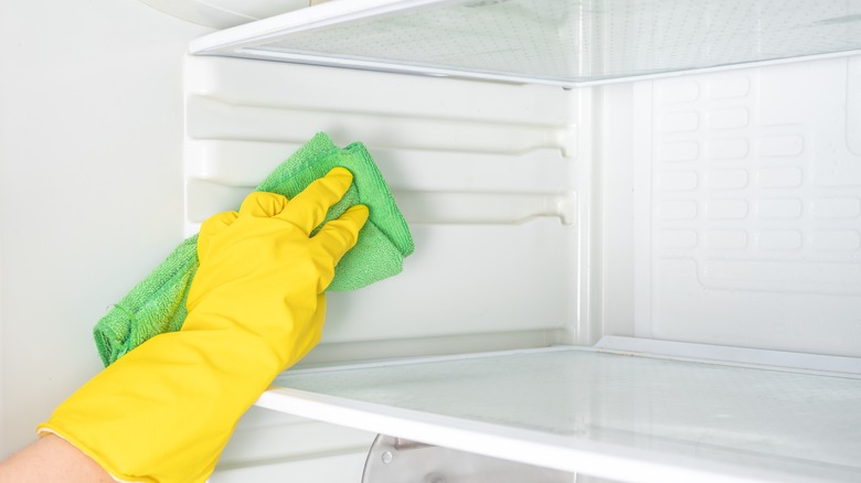 person cleaning fridge