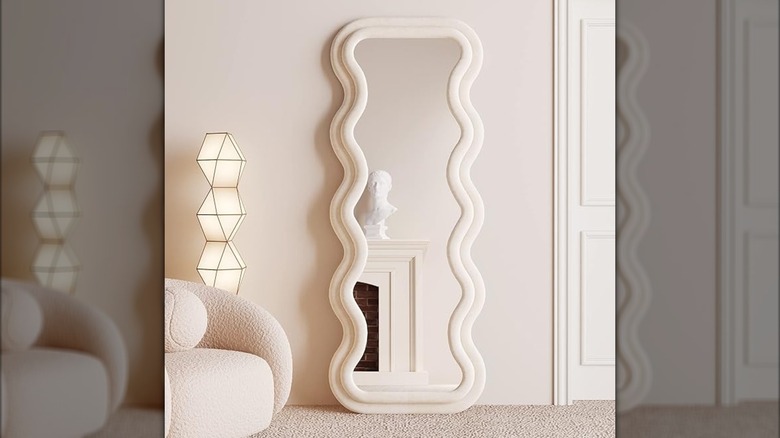 White wavy mirror on living room floor