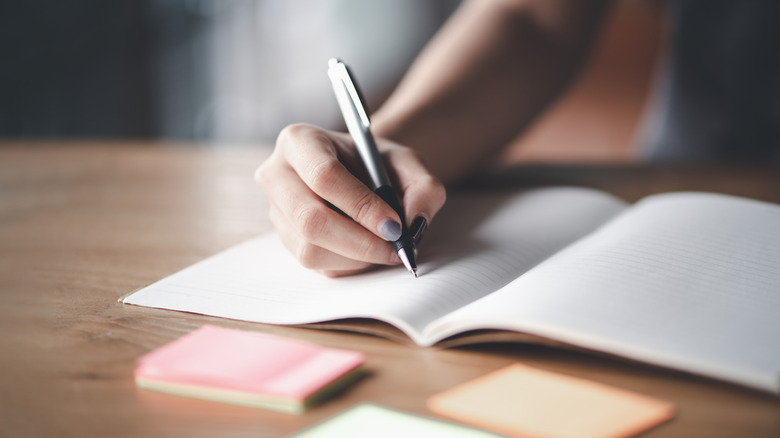 Person writing in journal