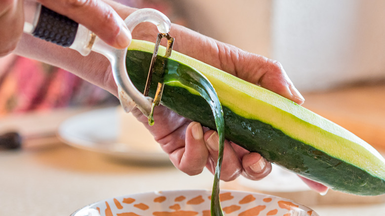 peeling off cucumber skin 