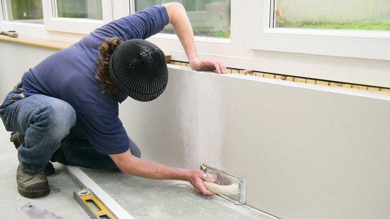 plastering a wall