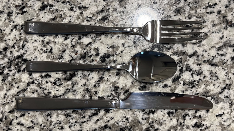 shiny silverware on countertop