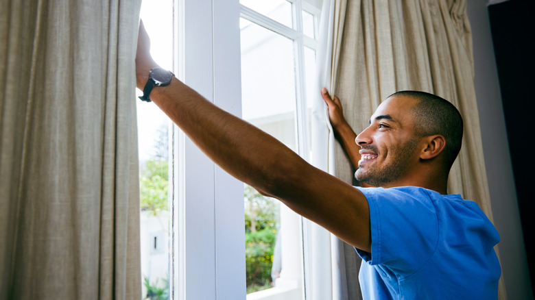 person opening window