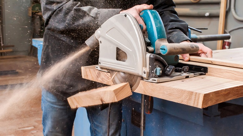 Person sawing off wood