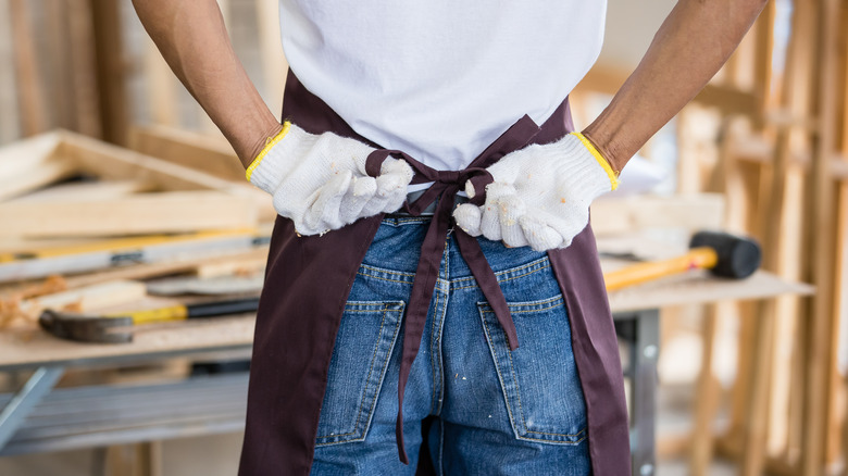 Carpenter tying apron