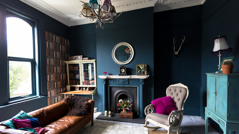 A living room with blue jewel-toned walls