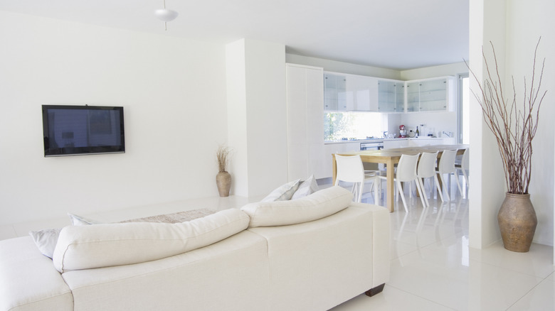 A living room and kitchen with bright white walls