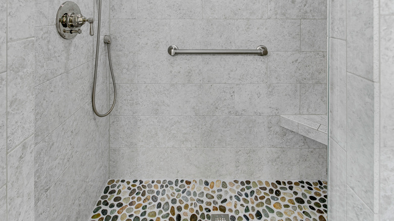 Tiled shower with a pebble tile floor