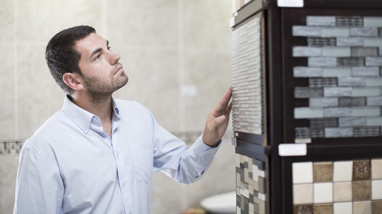 Man looking at samples of backsplash tiles in store