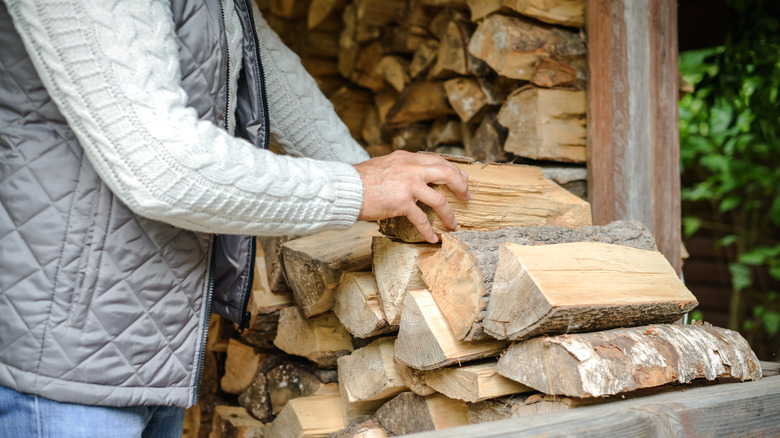 person stacking firewood